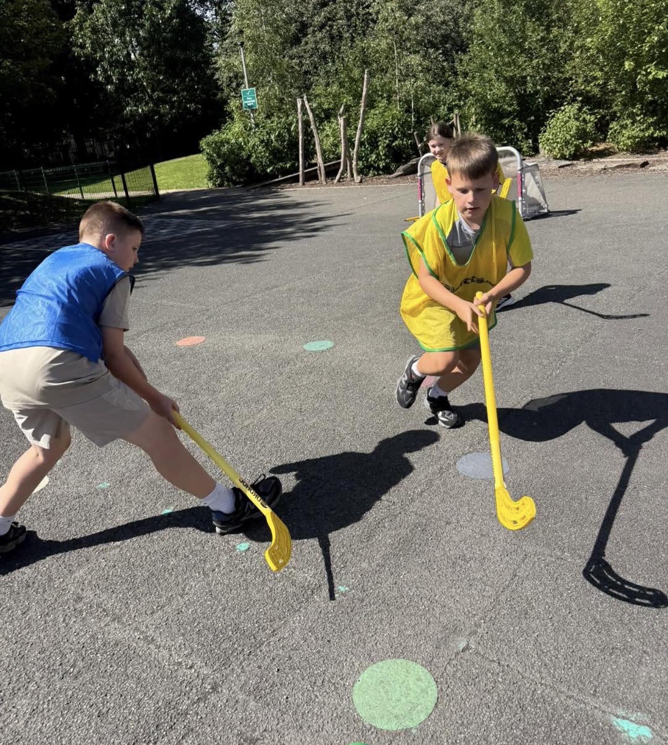 Children playing floorball on a school playground