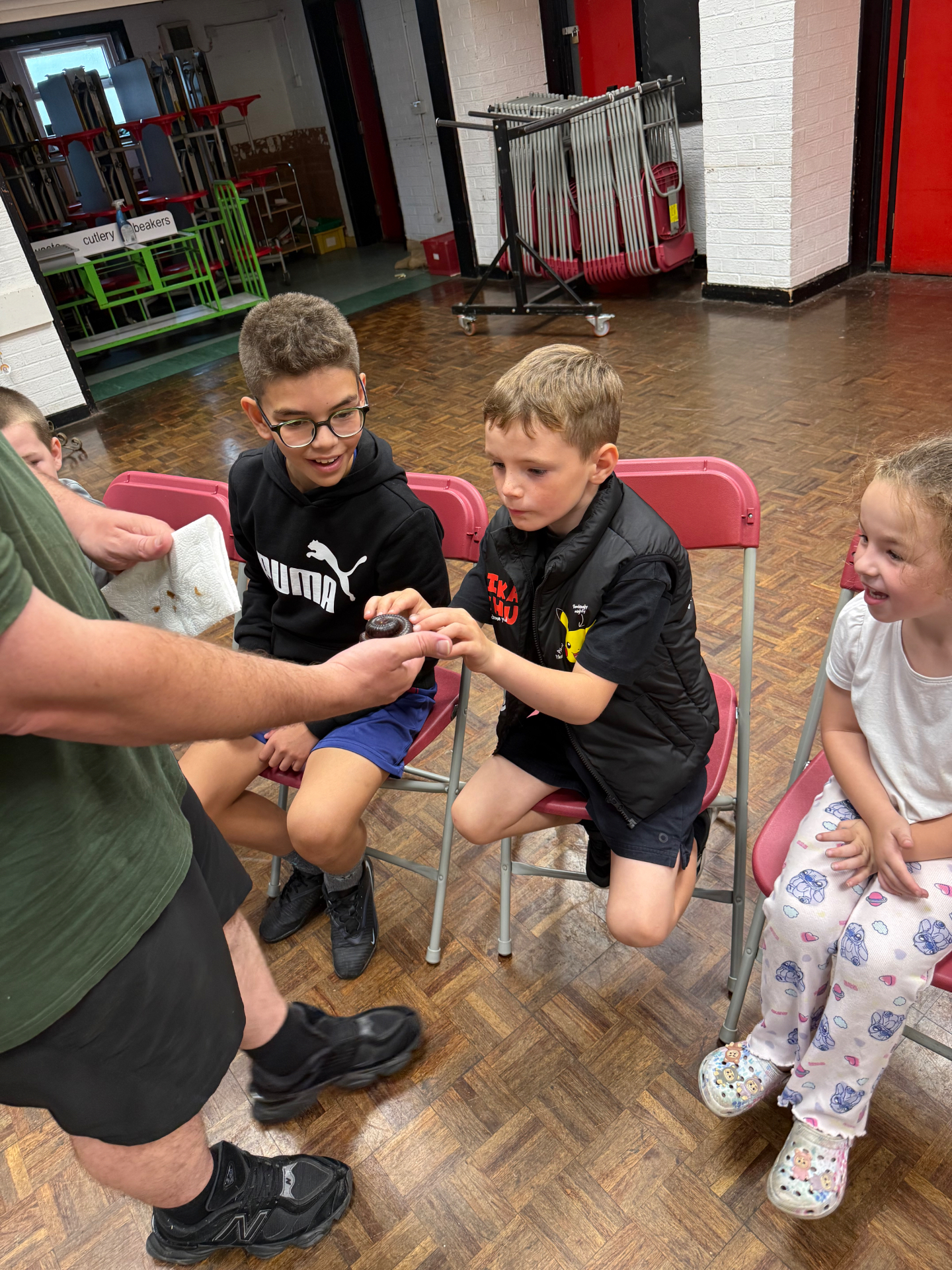 Coach working with primary school children in a school hall
